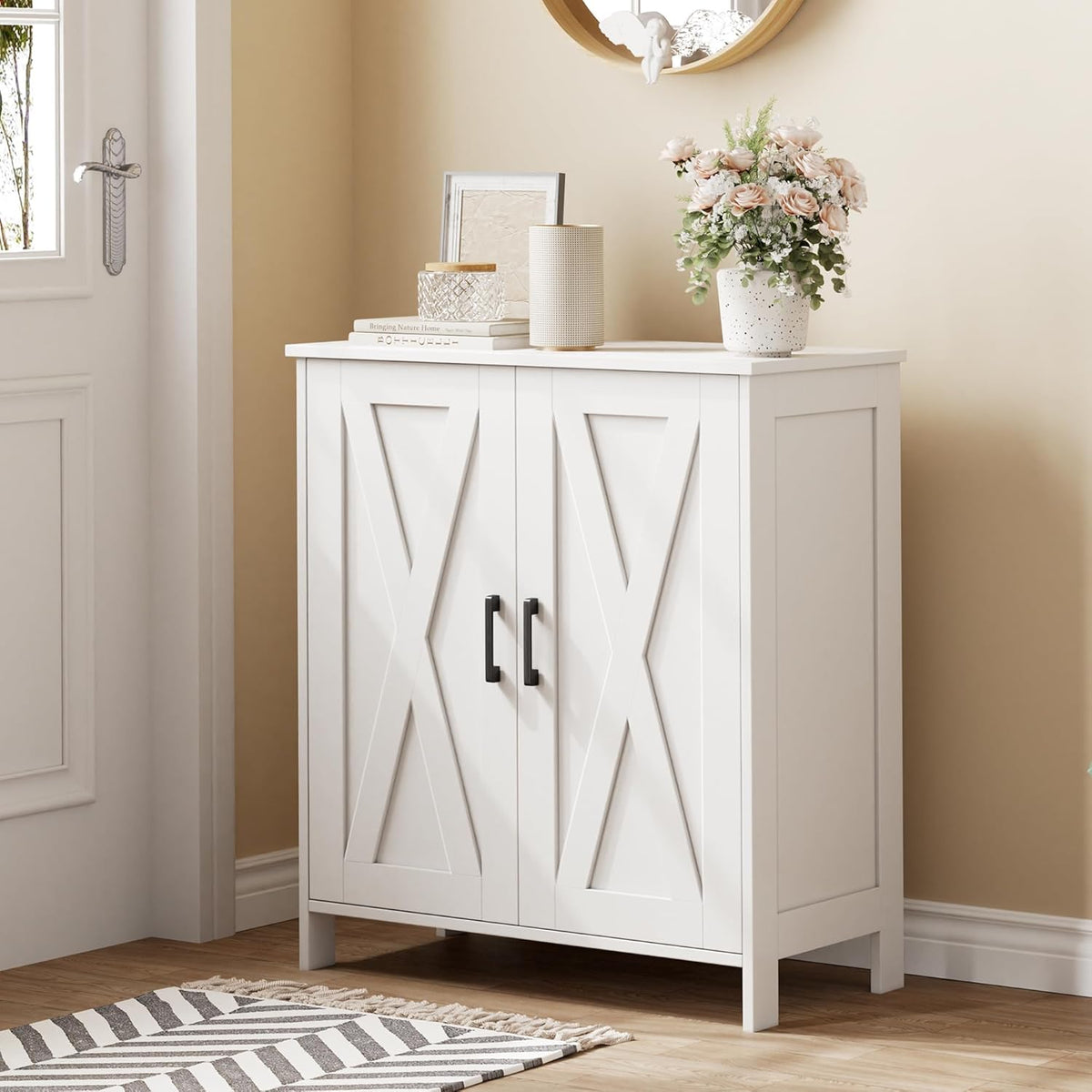 Closed white farmhouse shoe cabinet with X-panel doors and black U-shaped handles in an entryway setting