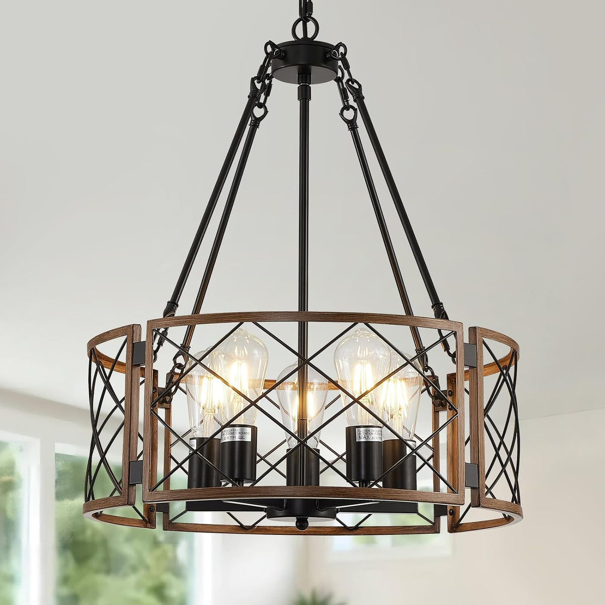 Close-up of chandelier top and circular wood-and-black metal cage showing exposed lit bulbs.