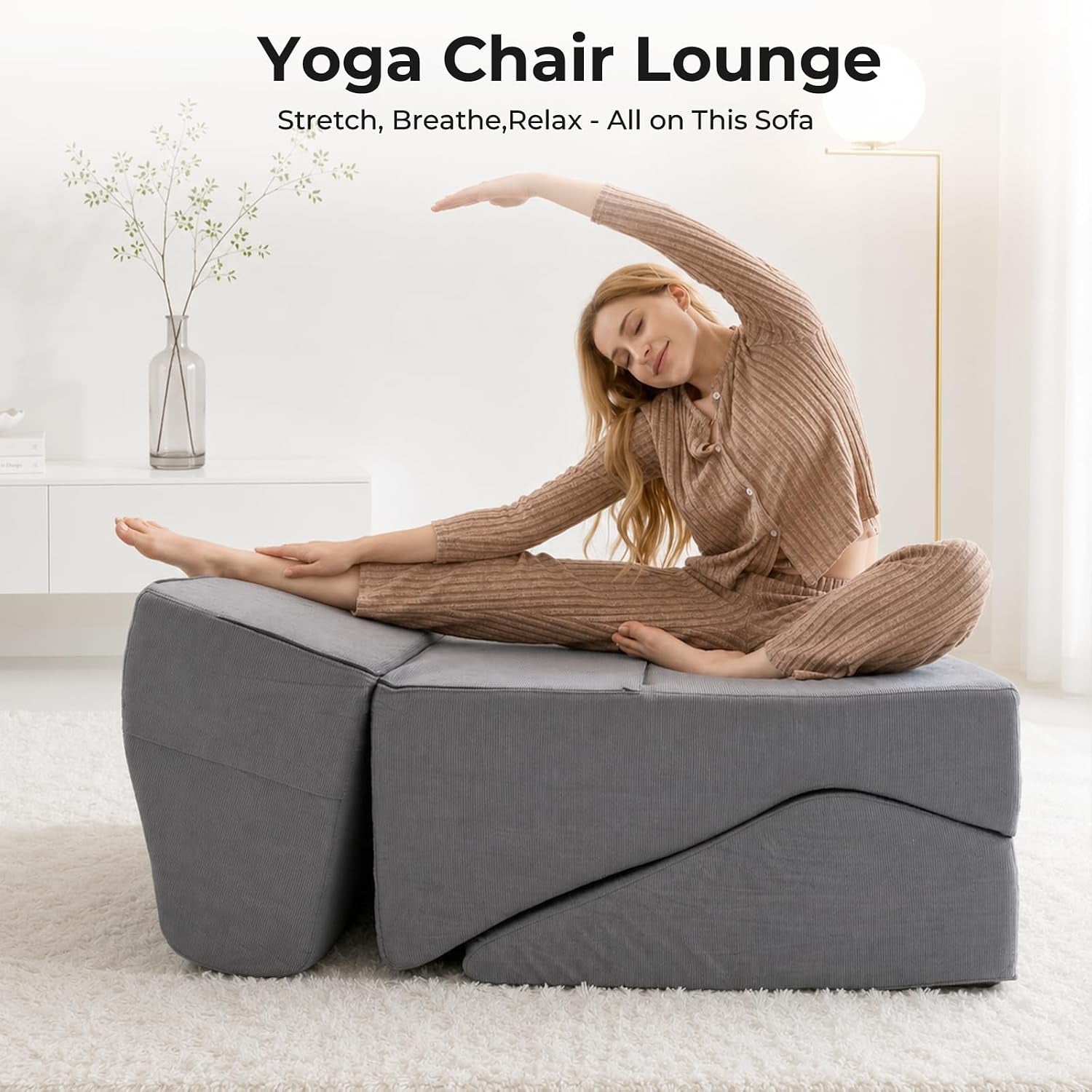 Grey chaise set in a yoga-stretch configuration with a person stretching on top in a bright room
