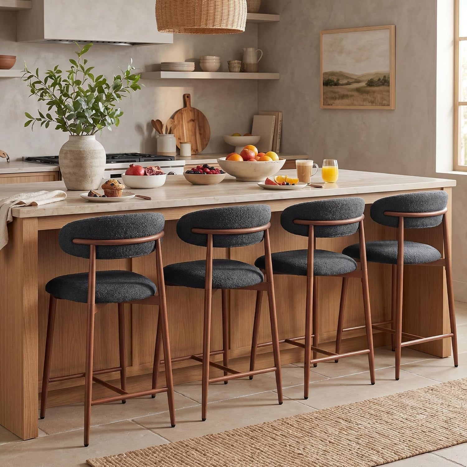 Row of four dark charcoal counter stools with bronze-toned metal legs tucked beneath a kitchen island.