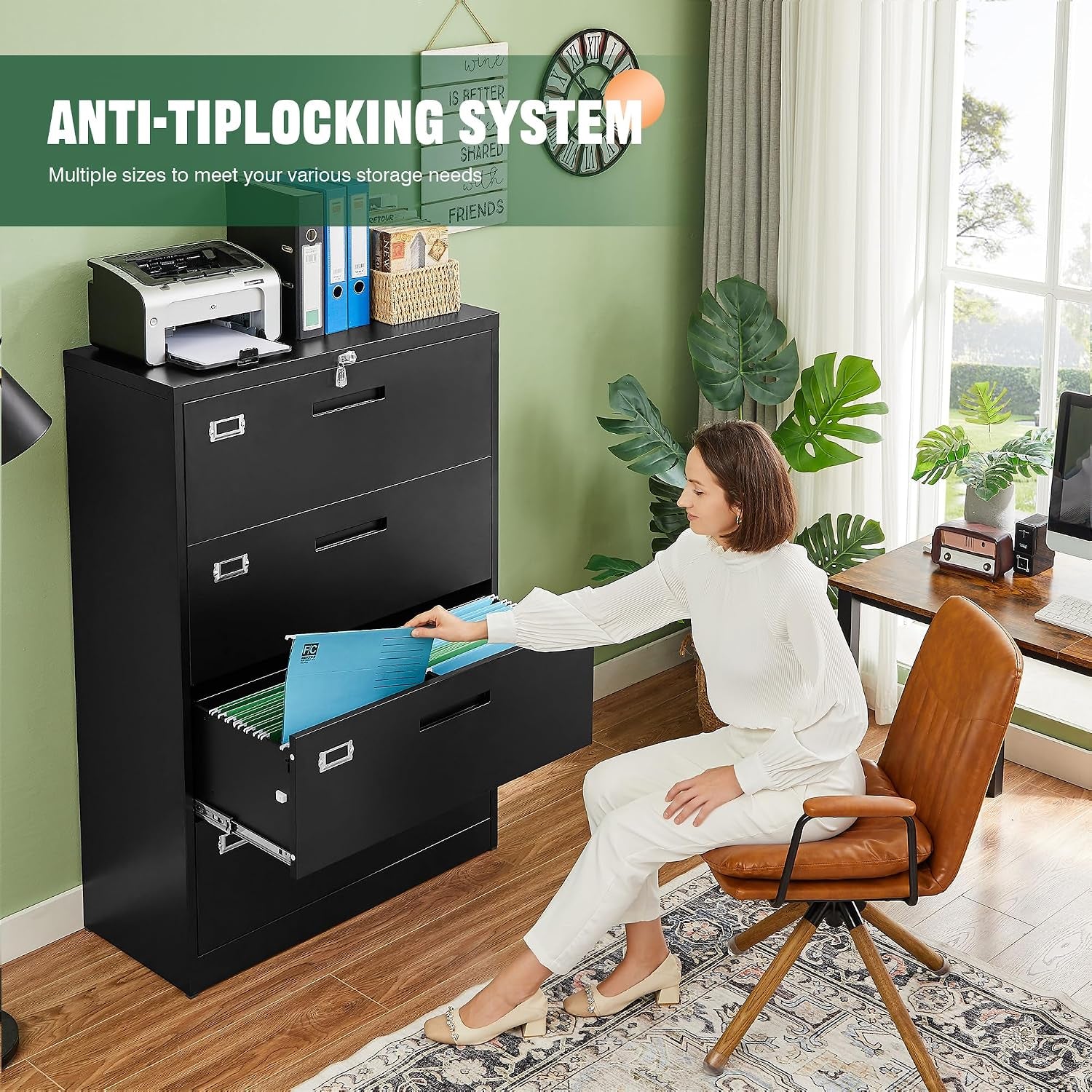 Seated woman removing hanging files from the open bottom drawer of a black four-drawer cabinet in a home office.