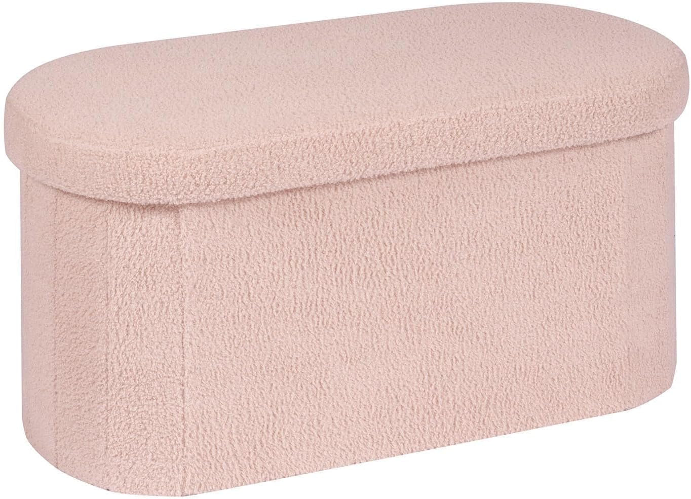 Long collapsible bench-style ottoman in pale pink sherpa fabric, shown from the side.