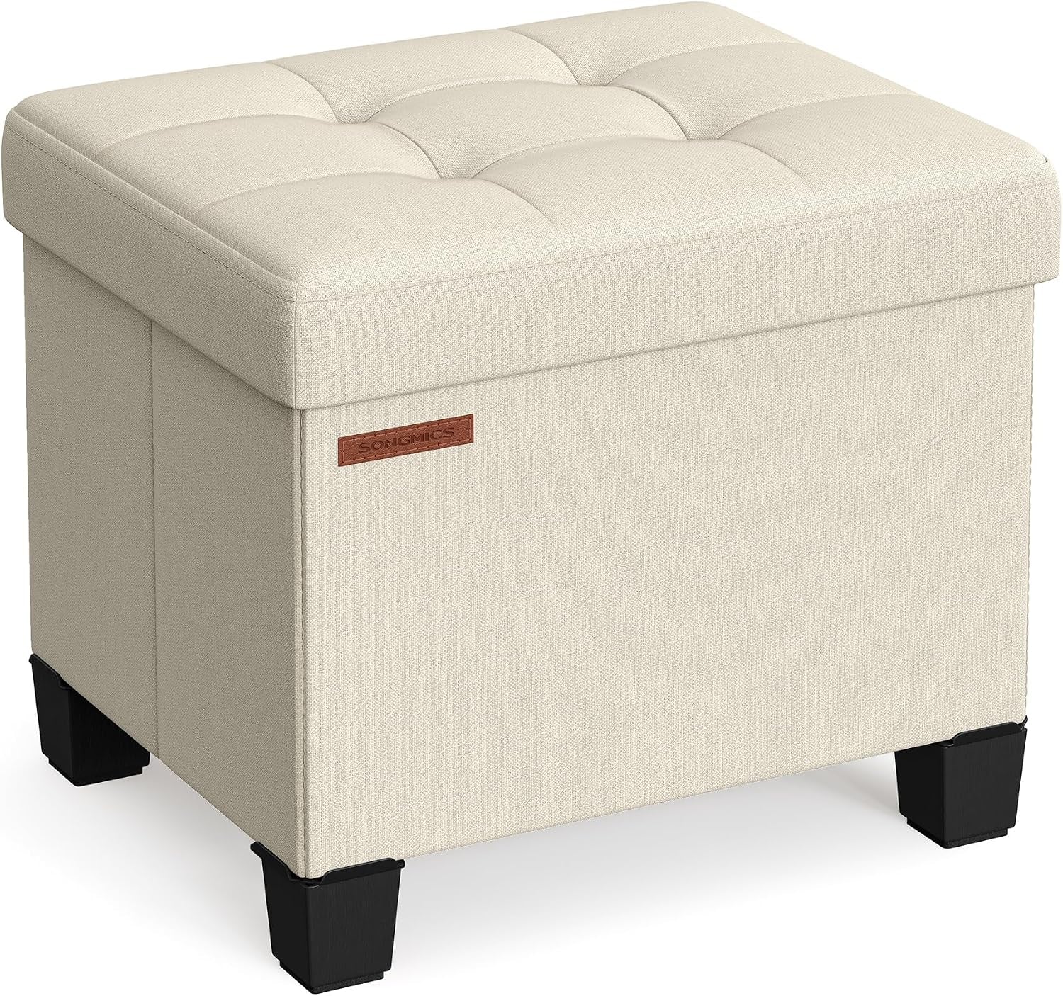 Cream linen-look square storage ottoman with tufted top and black block legs, angled view.