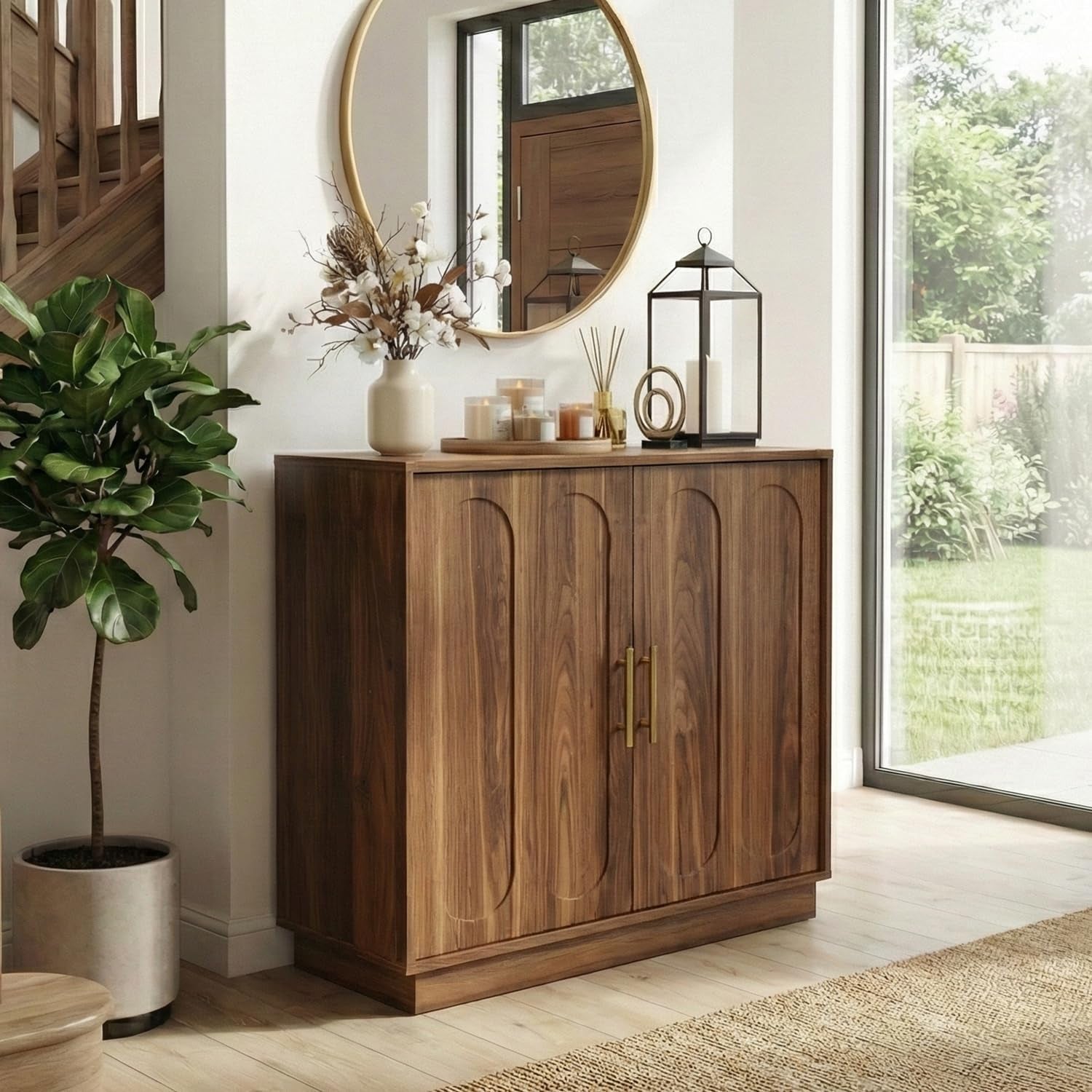 Close view of a rustic brown fluted cabinet with gold handles standing next to a potted fiddle leaf fig.