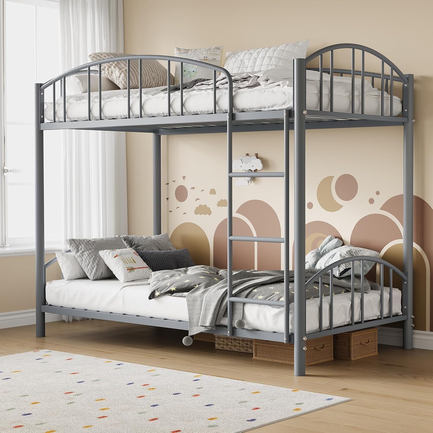 Gray metal twin-over-full bunk bed with ladder, styled in a child's room with wall decals and rugs.