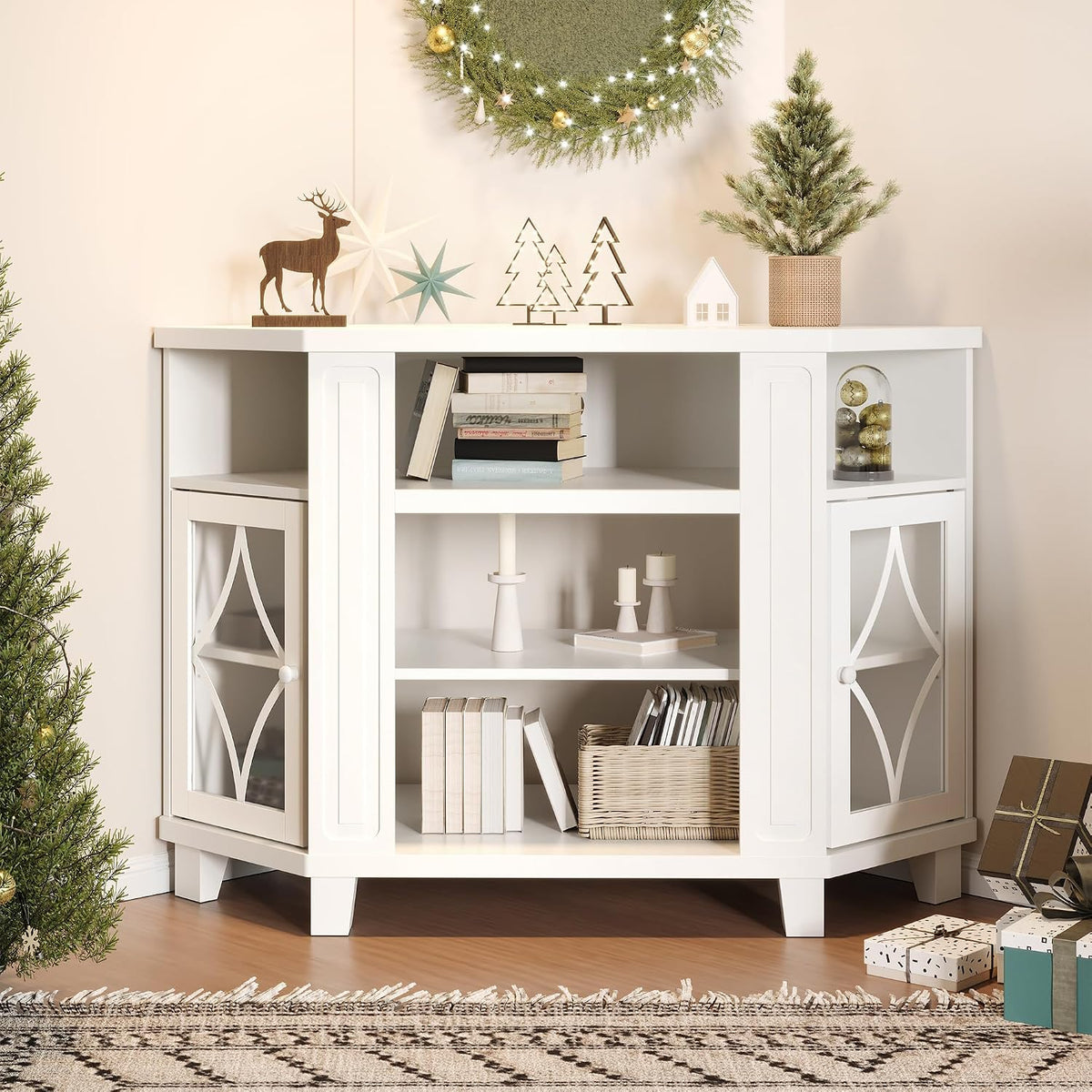 Styled room scene with white corner TV stand decorated for holidays, open shelves with books and baskets
