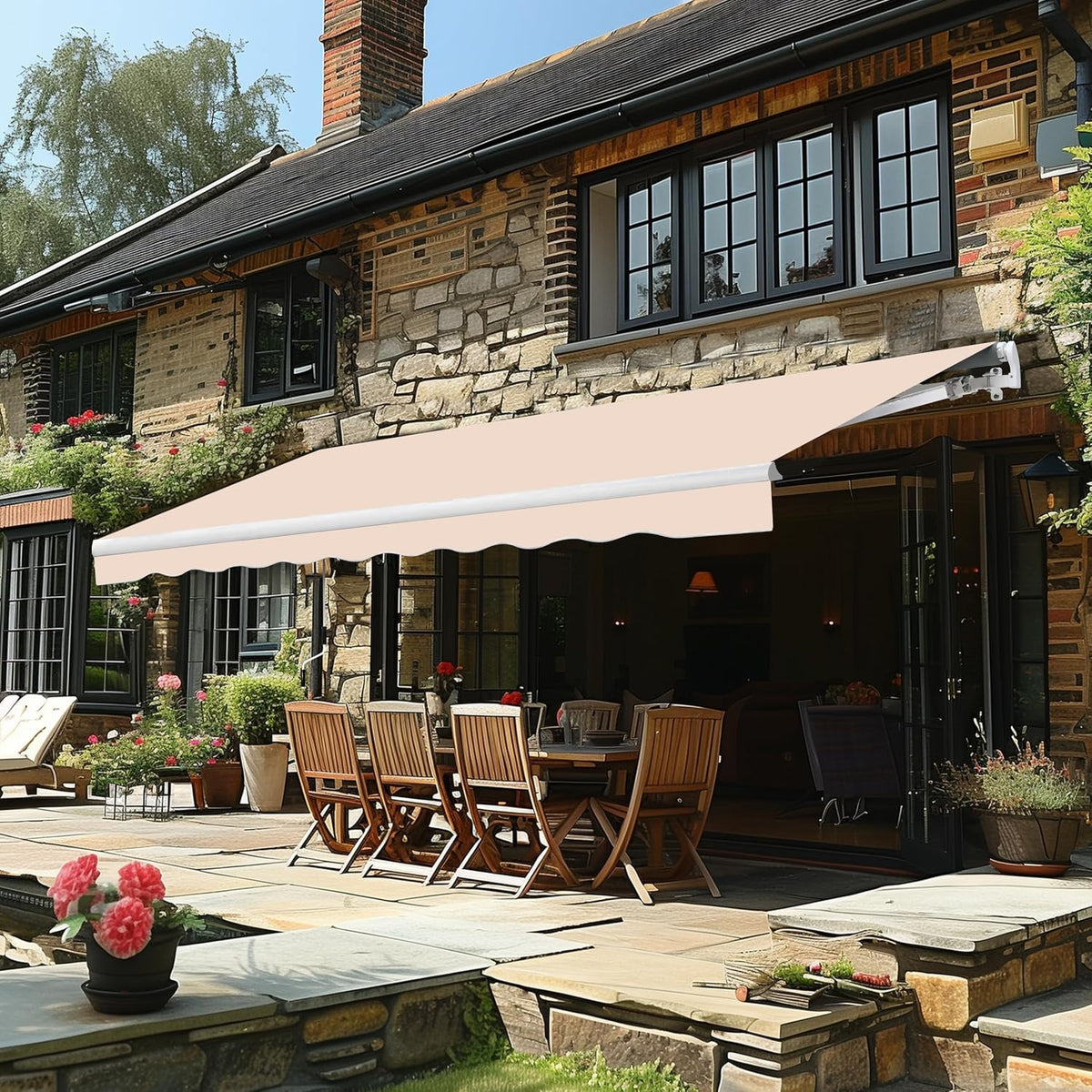 Beige-pink awning mounted above a stone house patio with outdoor dining set beneath.
