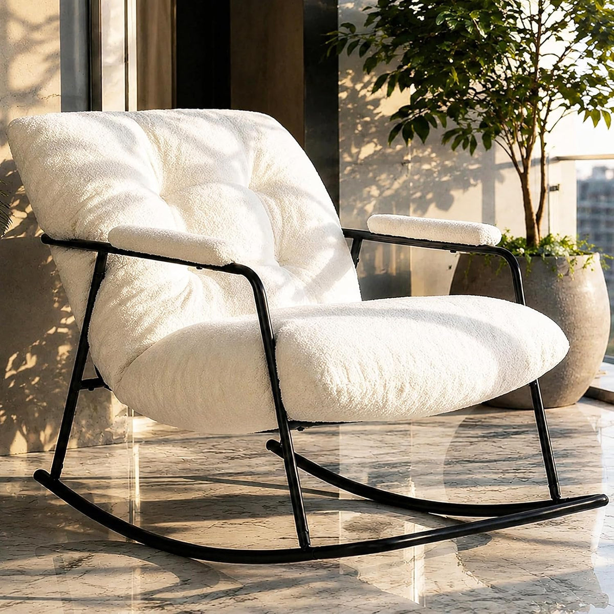 Close three-quarter view of a white bouclé upholstered rocking chair with tufted cushions and black metal rocker base.