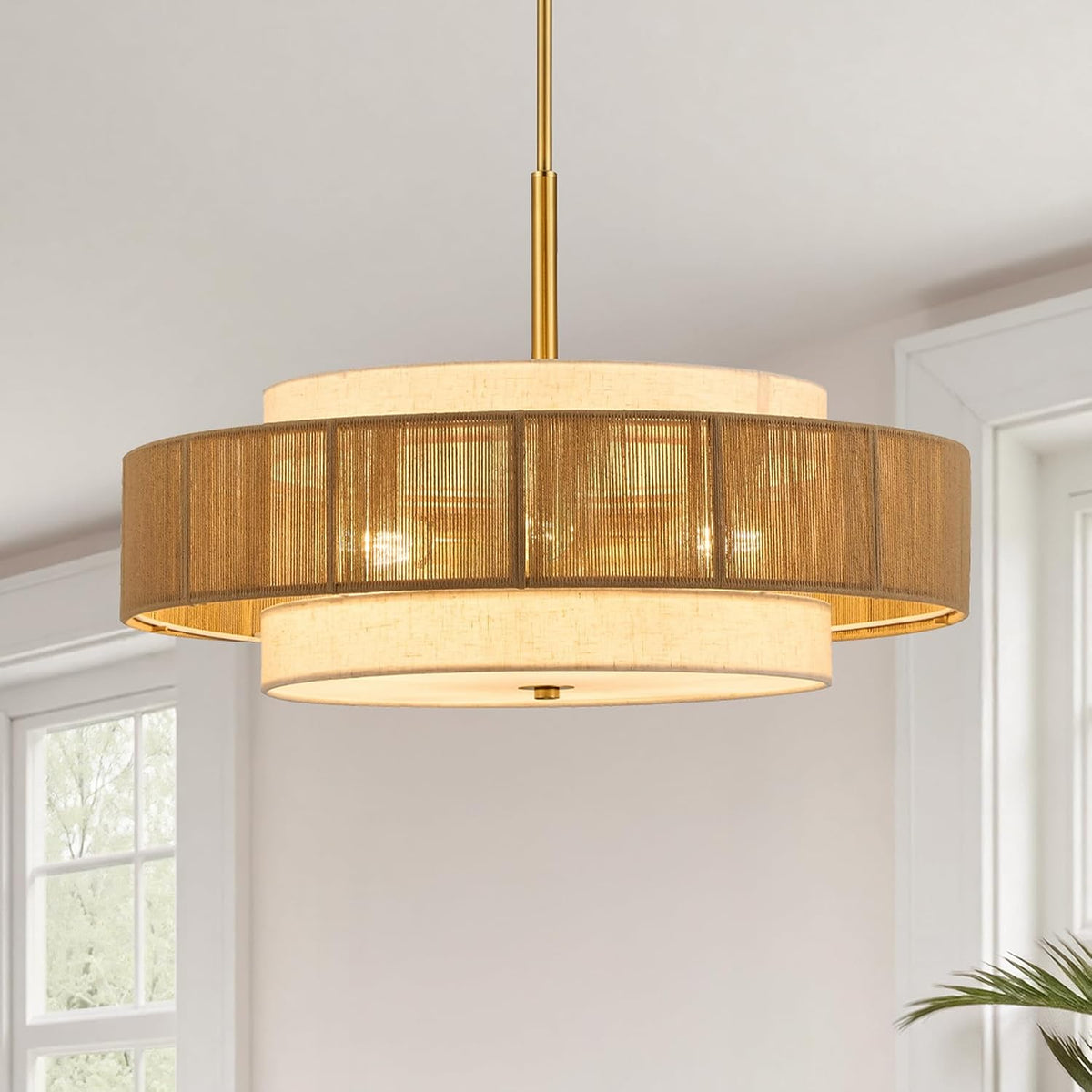 Side/angled view showing the chandelier with a textured bronze-toned outer drum and illuminated inner shade.