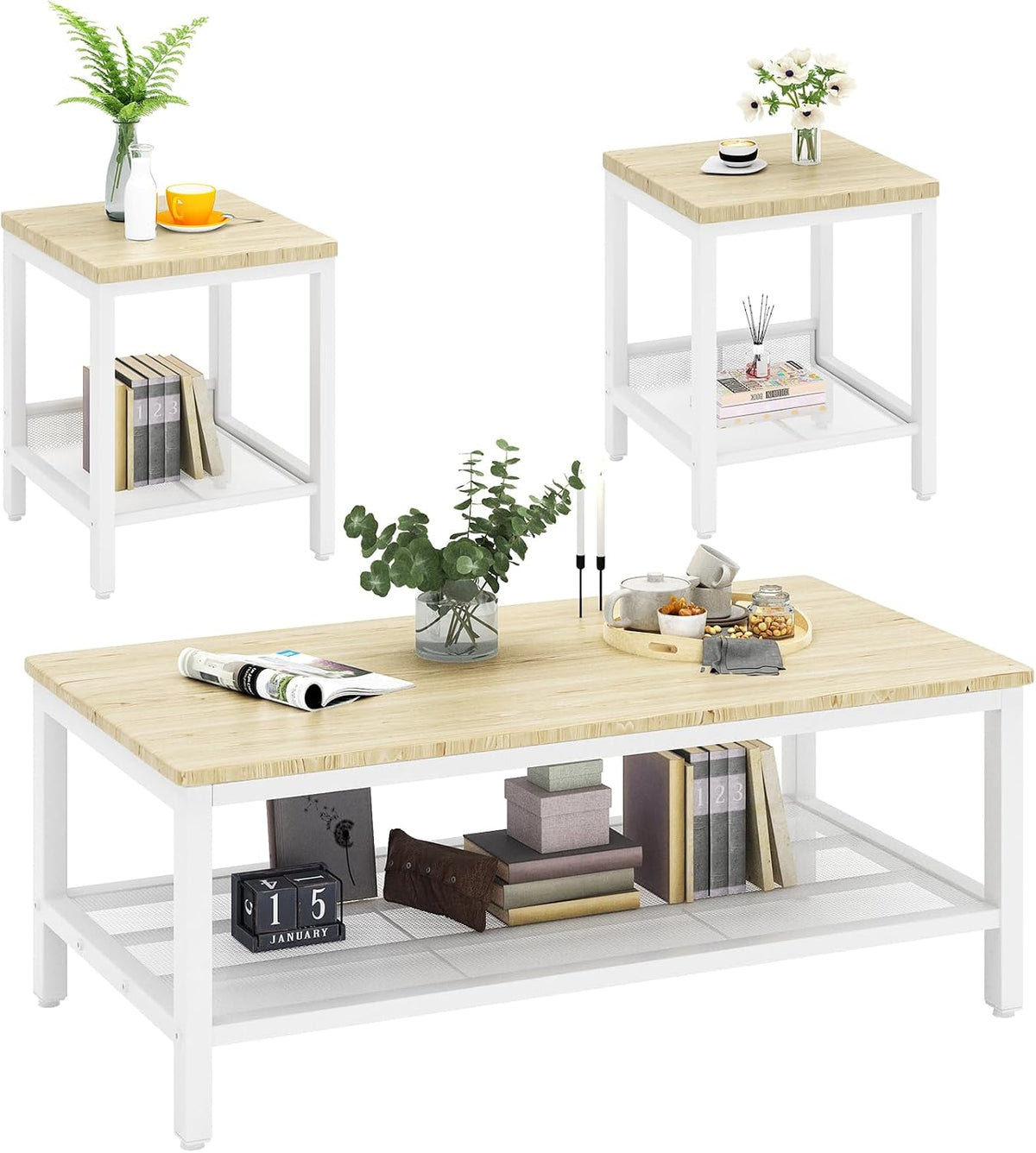 Studio view of three-piece tables with white metal frames and light natural wood tops, staged with decor.