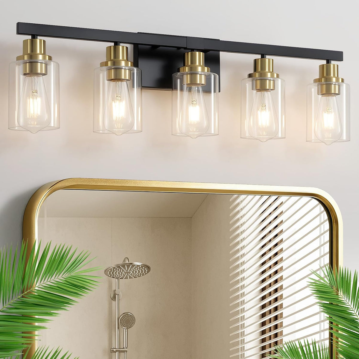 Five-light vanity fixture with clear glass shades, black bar and brass-toned sockets above a mirror