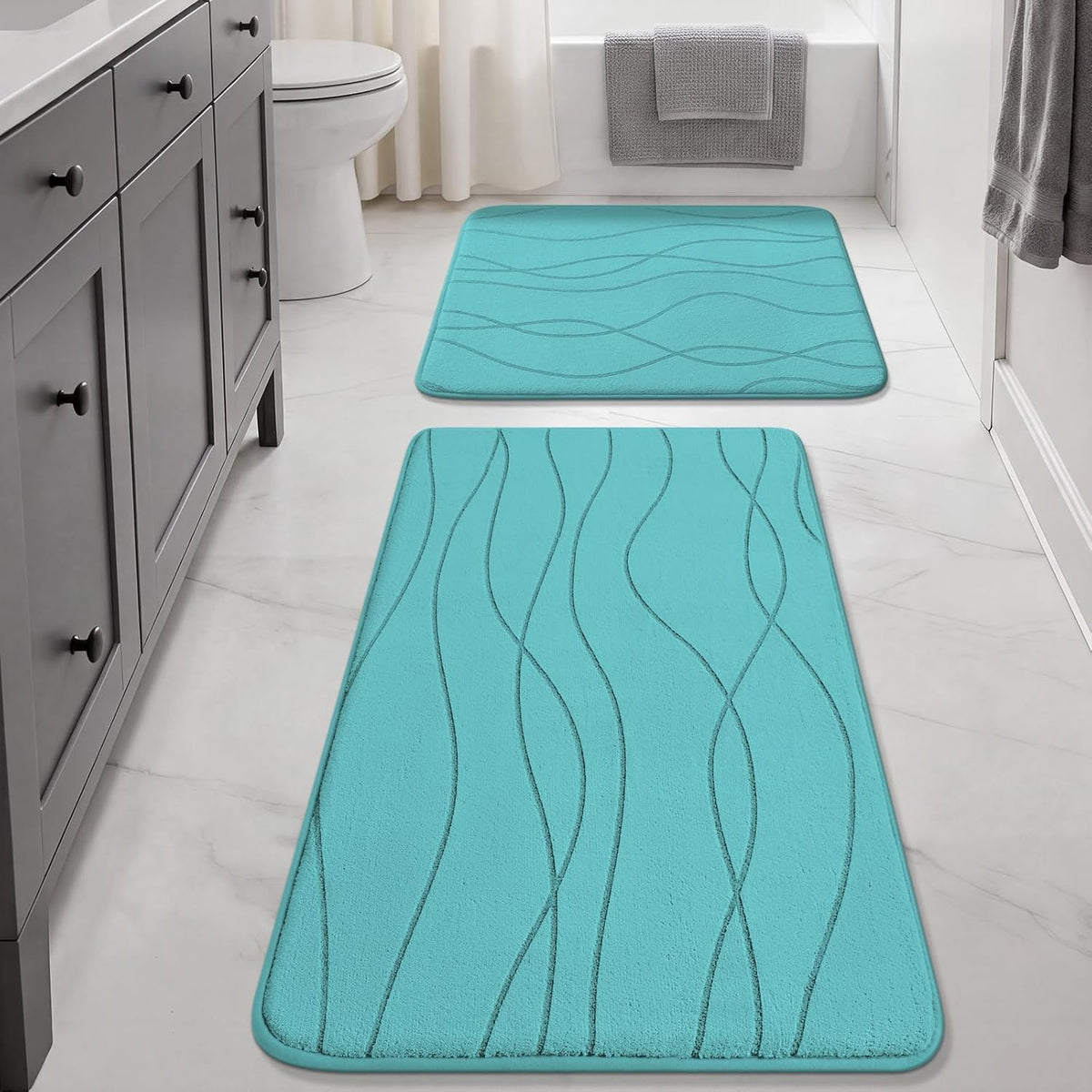 Long teal runner and matching square mat placed in a bright bathroom with white fixtures