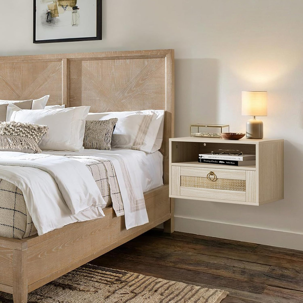 Wall-mounted light oak nightstand with rattan-front drawer beside a woven headboard, lamp and books in a neutral bedroom.