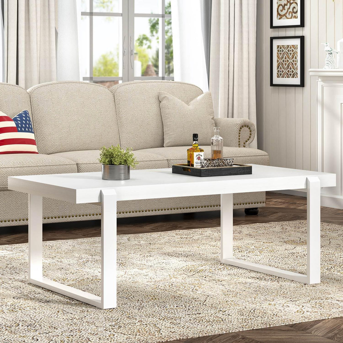 White rectangular coffee table with matching white U-shaped metal legs in a bright living room.