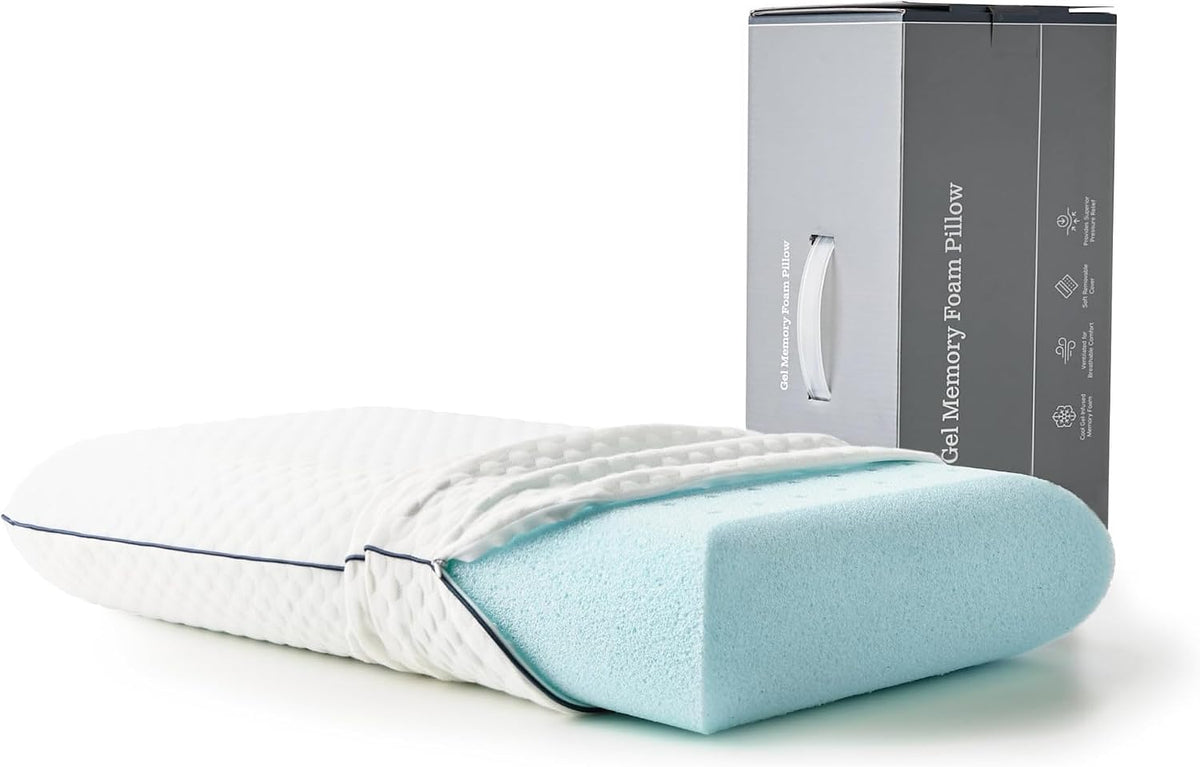 Angled close-up of a white quilted pillow with the light-blue gel foam core partially exposed and a tall gray box at right.