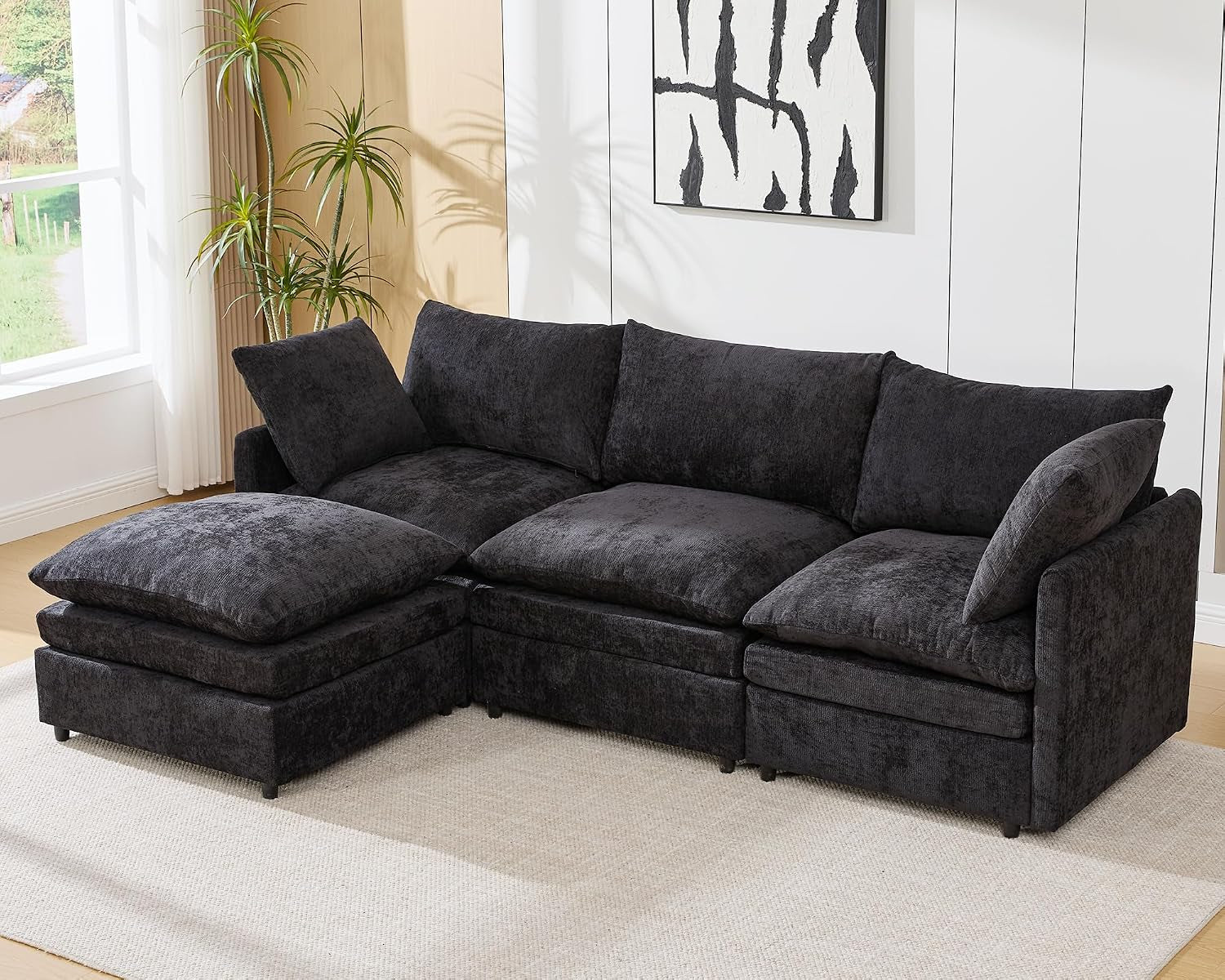 Dark gray three-seat L-shaped sectional with a left ottoman.