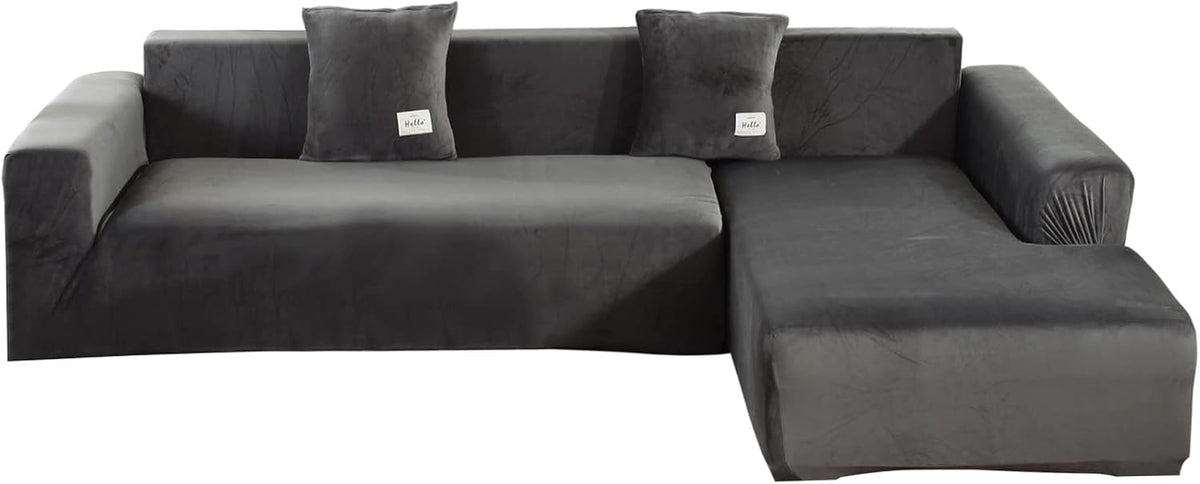 Isolated front view of the L-shaped slipcover set in dark gray on white background