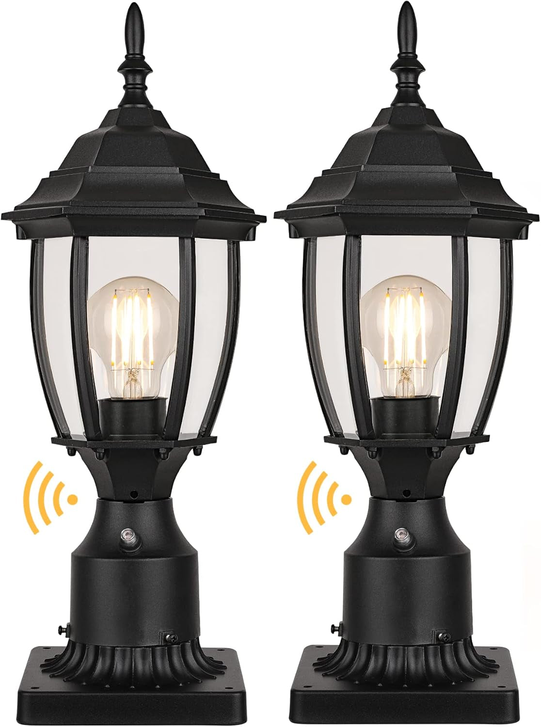 Pair of black post lanterns front-facing on bases, each showing a clear bulb and small round photocell window.