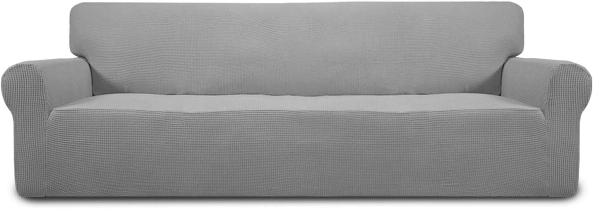 Front view of a loveseat with a light gray textured stretch slipcover fitted over arms and seat
