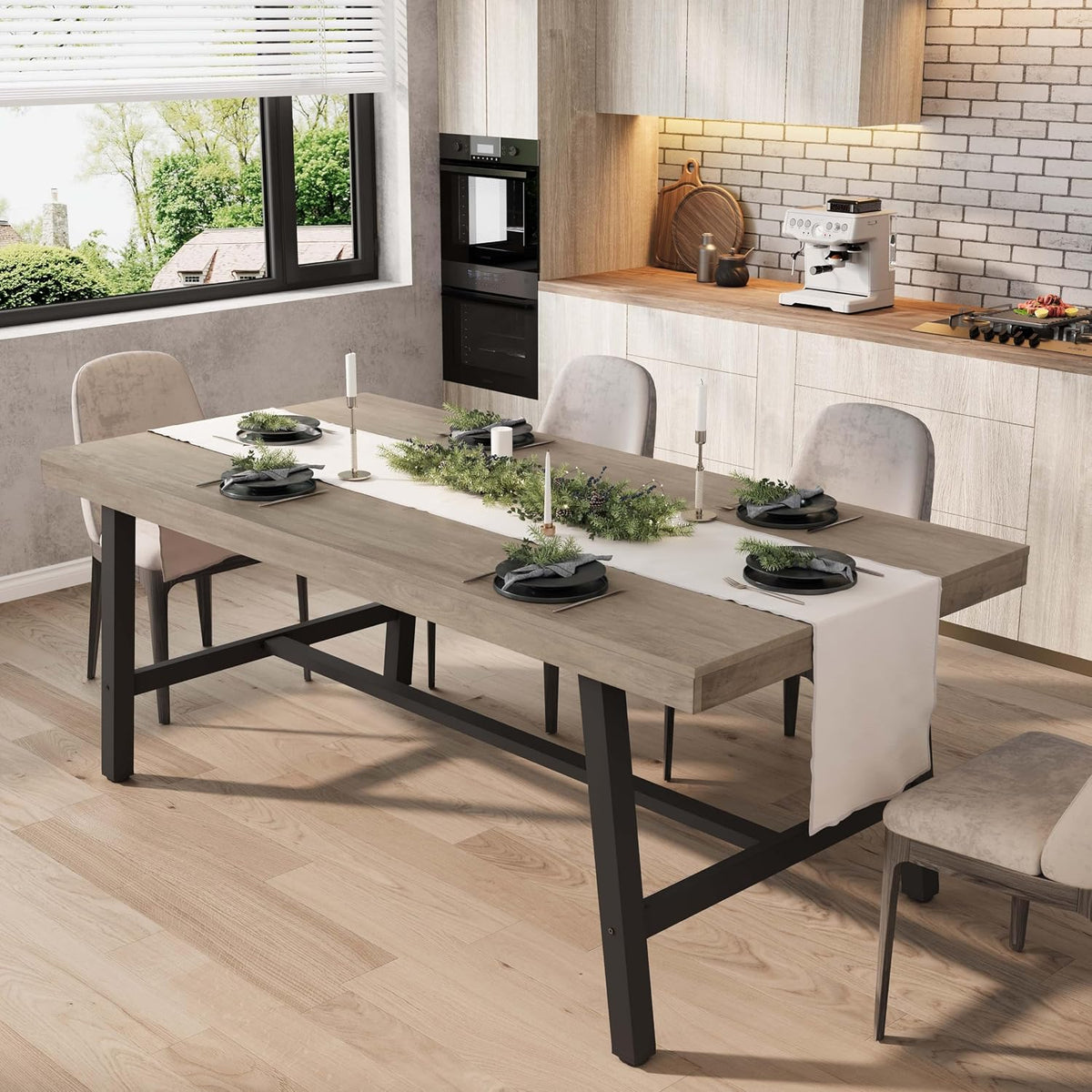 Rectangular dining table with light gray wood top and black metal legs set for six in a bright kitchen.