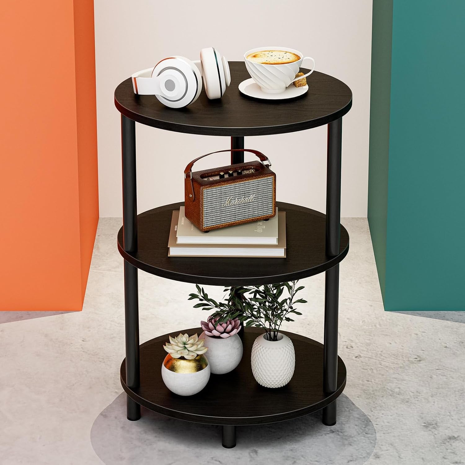Single black round three-tier end table shown with headphones, a cup and small decor on each shelf.