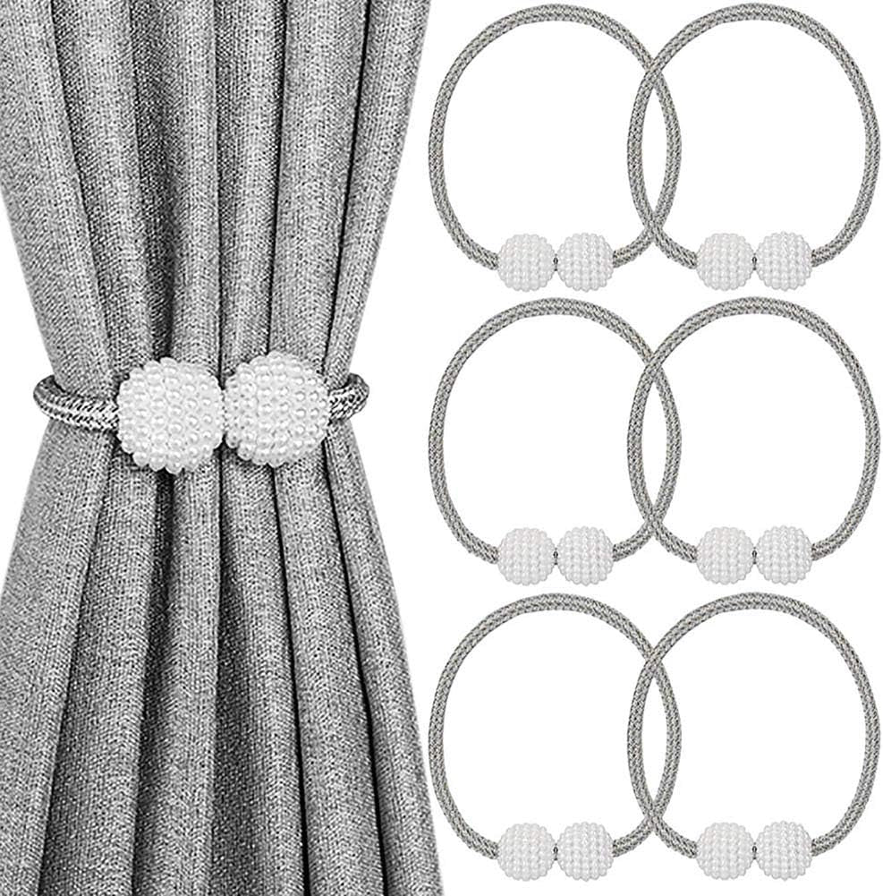 White beaded magnetic curtain tieback holding back a grey curtain with five additional tiebacks shown.