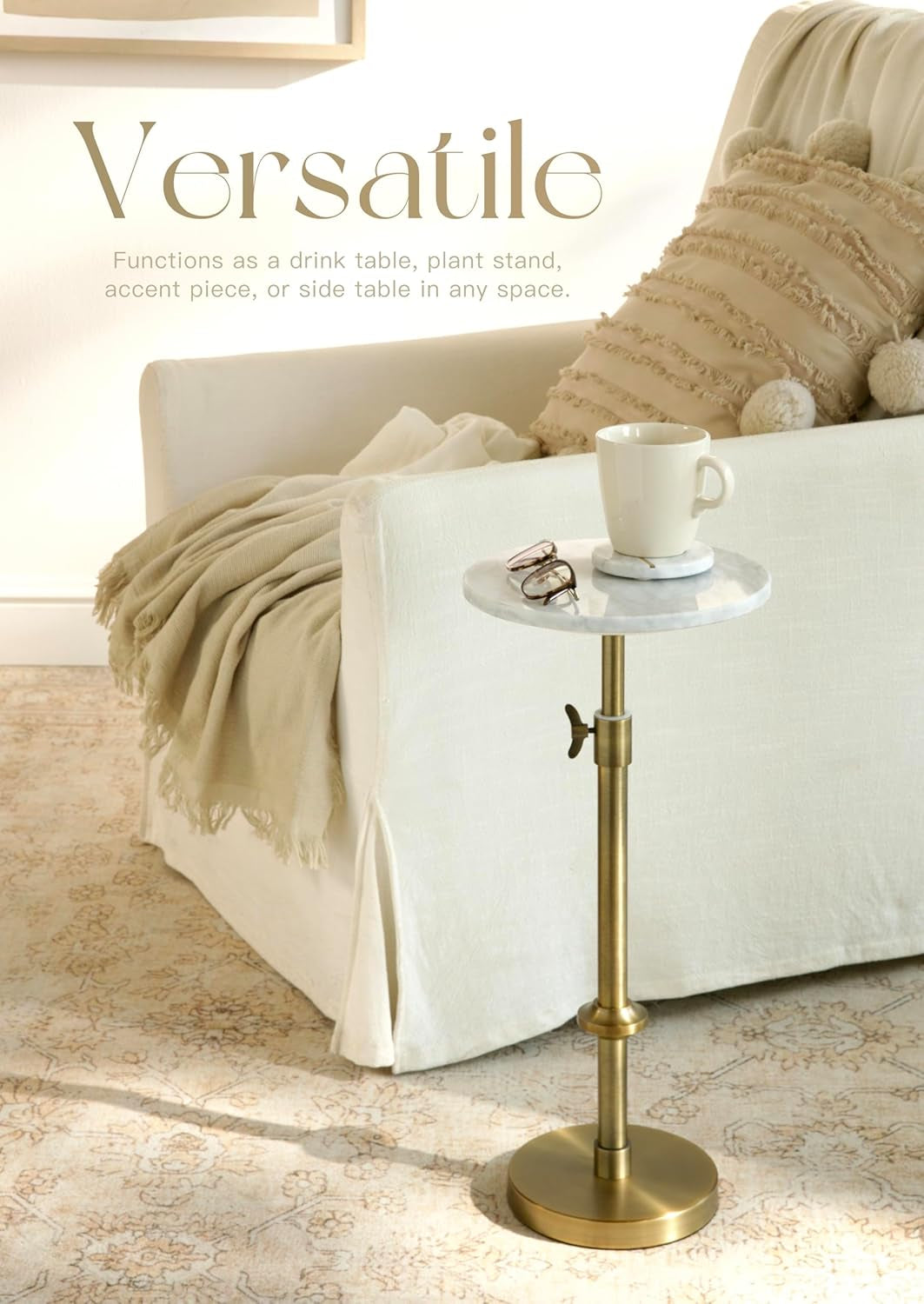 Marble-topped pedestal table beside a sofa with a mug on a coaster and decorative throw