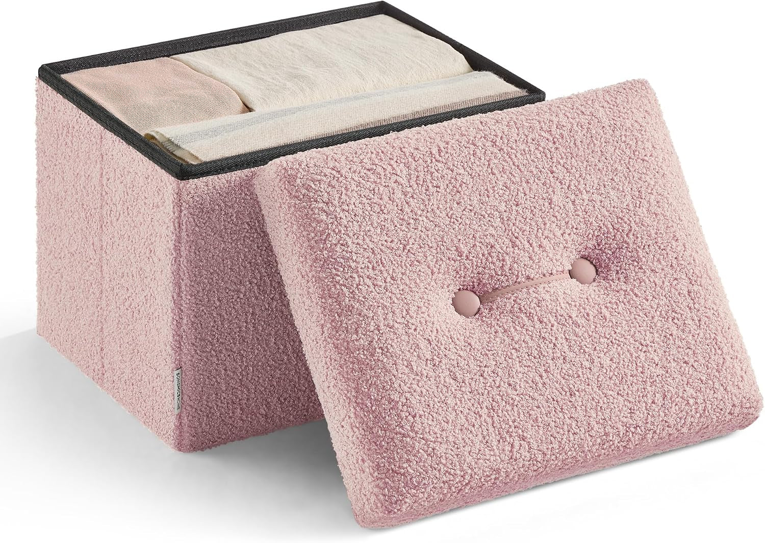 Small square storage ottoman with fuzzy pink cover and removed lid showing folded clothes inside