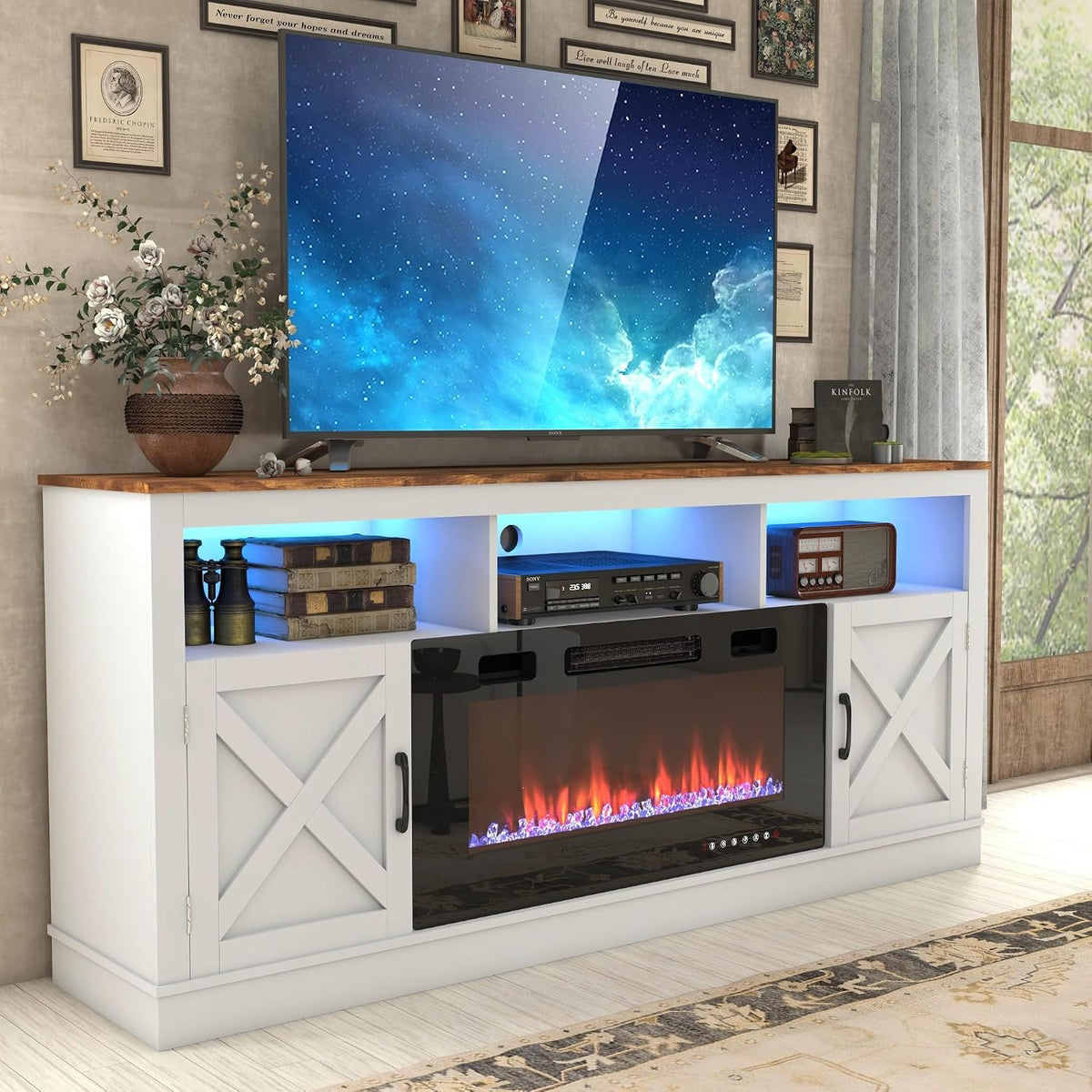 Angled view of the white TV stand with brown top, blue-lit open cubbies and vase beside a large flat-screen.