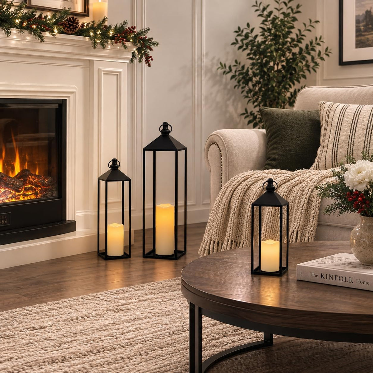 Black metal lantern set with lit LED candles staged near a fireplace and on a coffee table in a living room