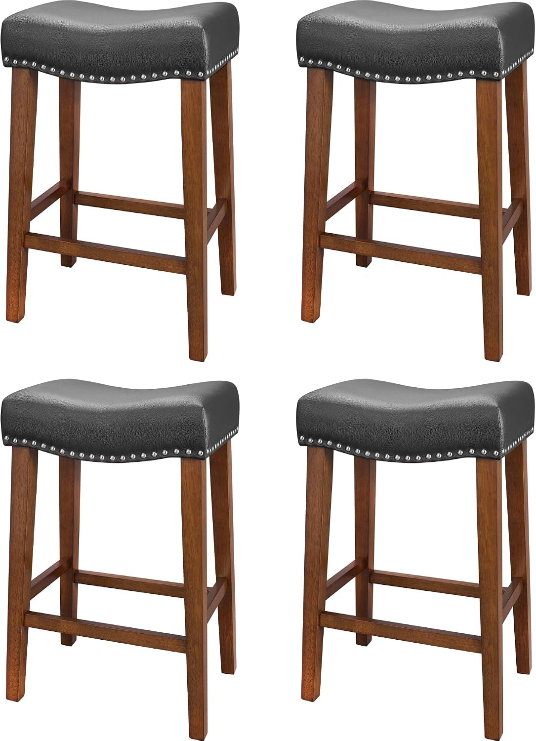 Four backless counter stools with dark gray seats, silver nailhead trim and warm wood legs arranged two by two.