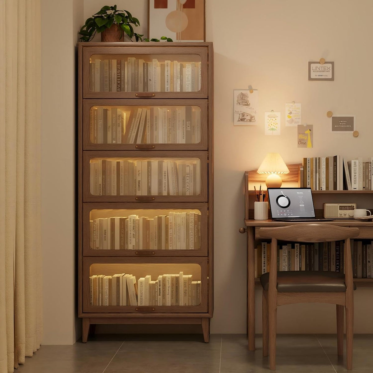 Four-tier wood bookcase with warm interior lighting next to a desk and chair in a cozy corner