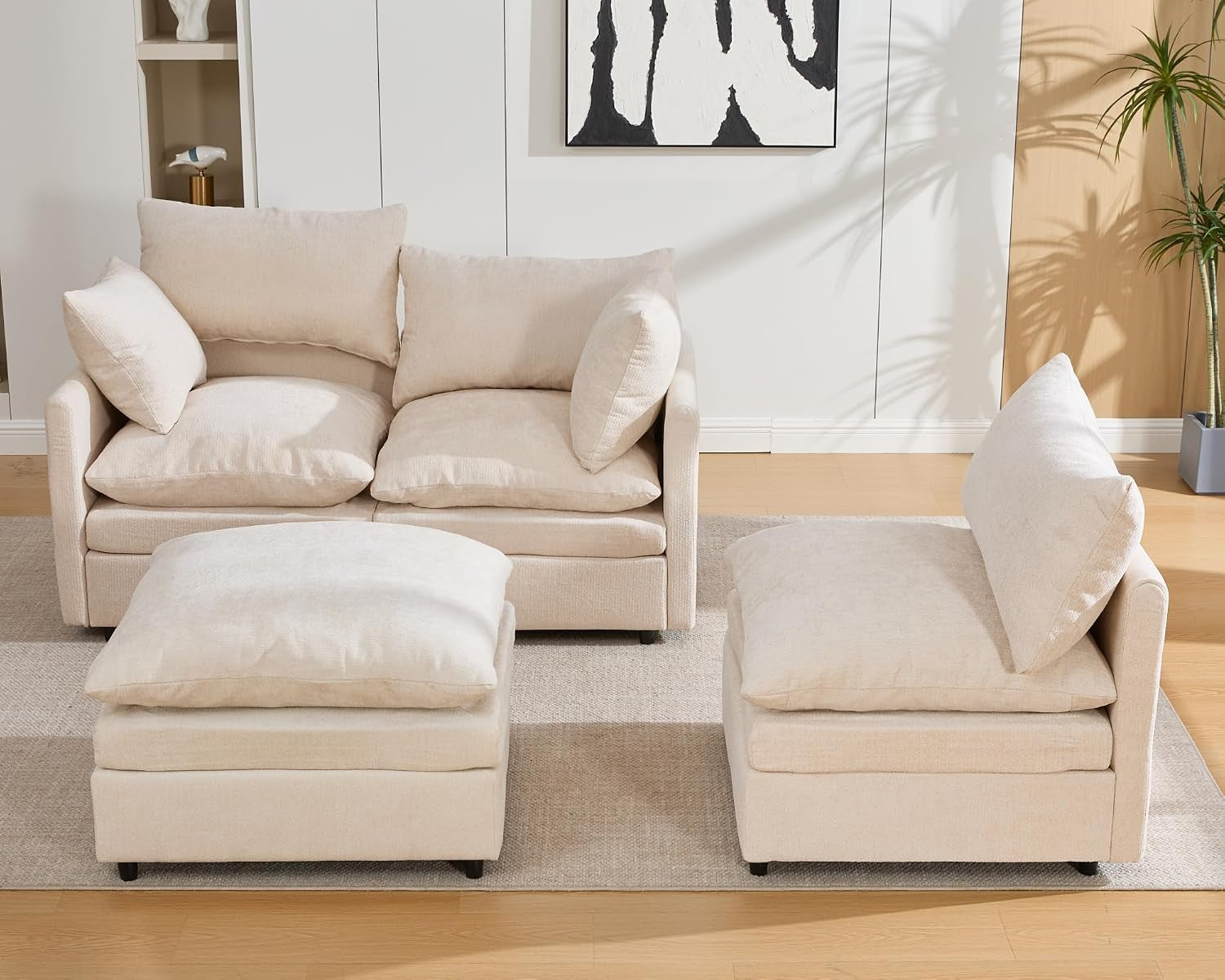 Cream modular set separated into a two-seat section, single seat and ottoman.