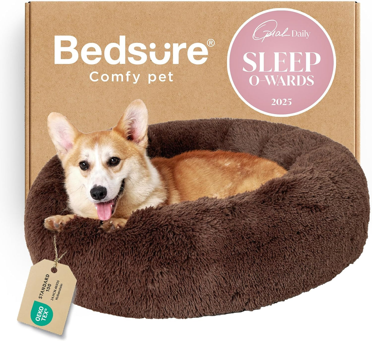 Front view of a dark brown faux-fur donut bed with a smiling corgi lying inside and a hanging tag visible at left.