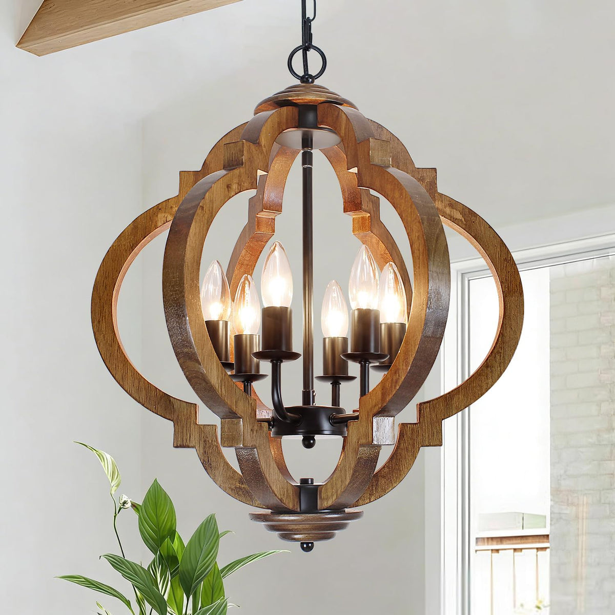 Tight view through a carved wooden orb showing inner candle arms and warm bulbs inside the wood frame