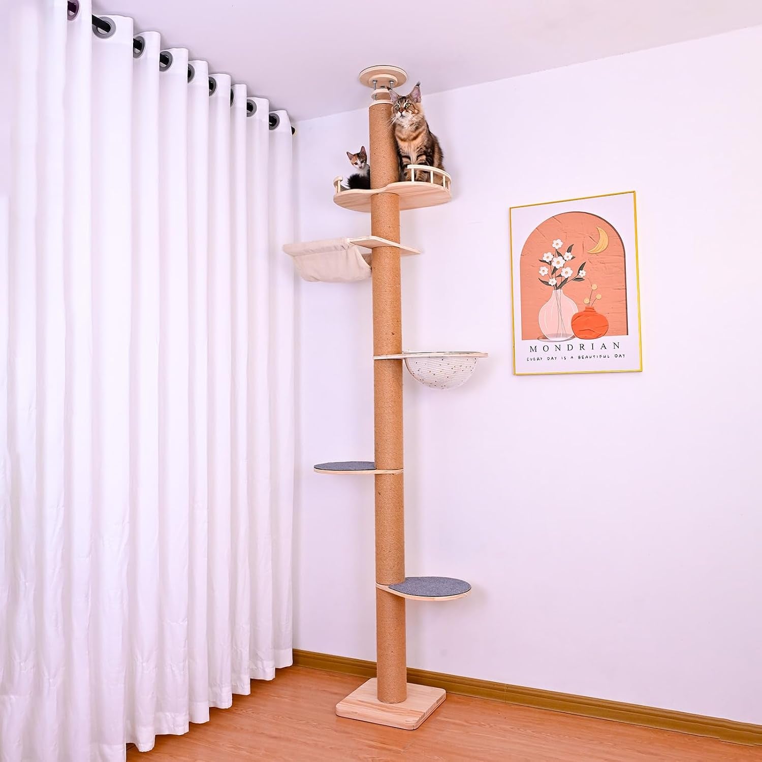 Tall sisal-wrapped cat pole with grey platform mats and two cats perched at the top in a corner lifestyle setting