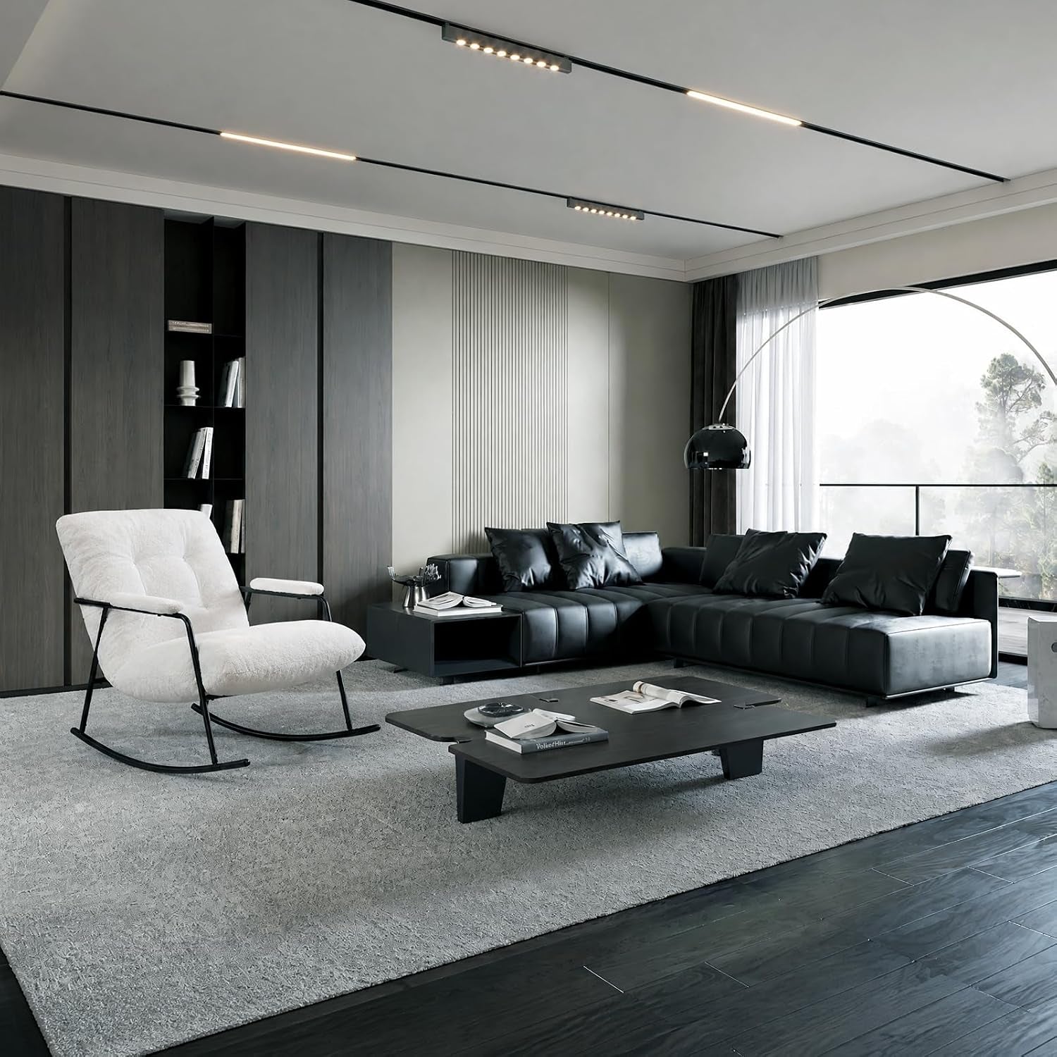 Wide living room shot showing the white rocking chair at left beside a low black coffee table and dark sectional.