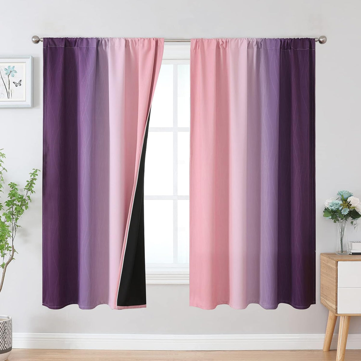 Full view of pink-to-violet gradient curtains with wavy line motif, one panel folded back showing dark blackout interior.