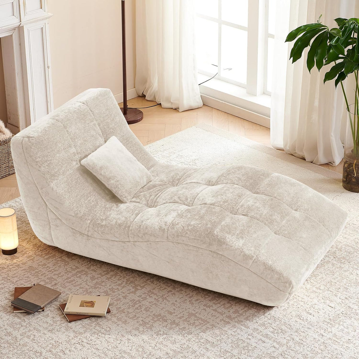 Beige tufted flannel chaise lounge angled front-right view in a living room setting with a small matching pillow