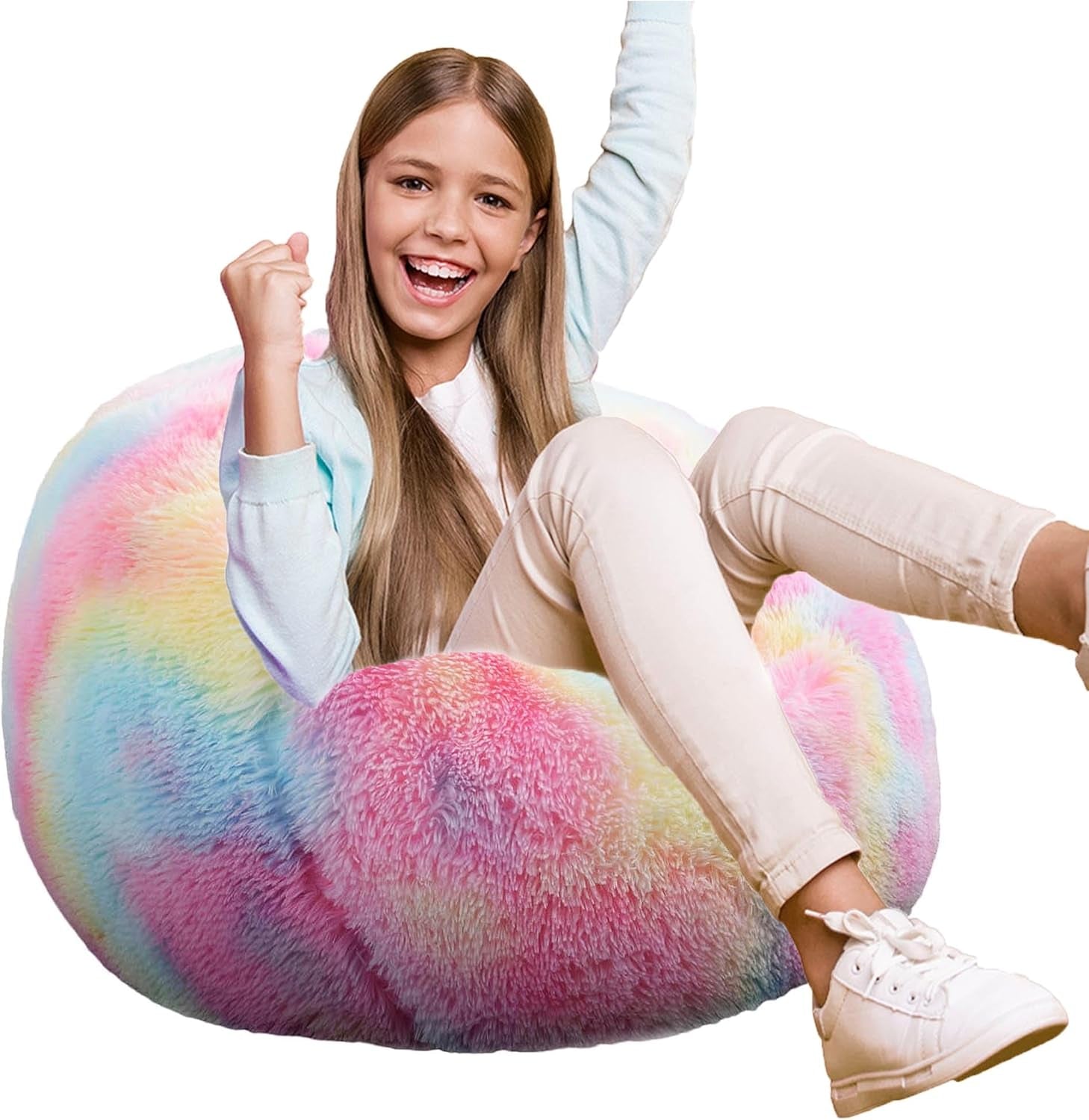 Smiling girl sitting and cheering on a pastel rainbow fluffy round bean bag chair.