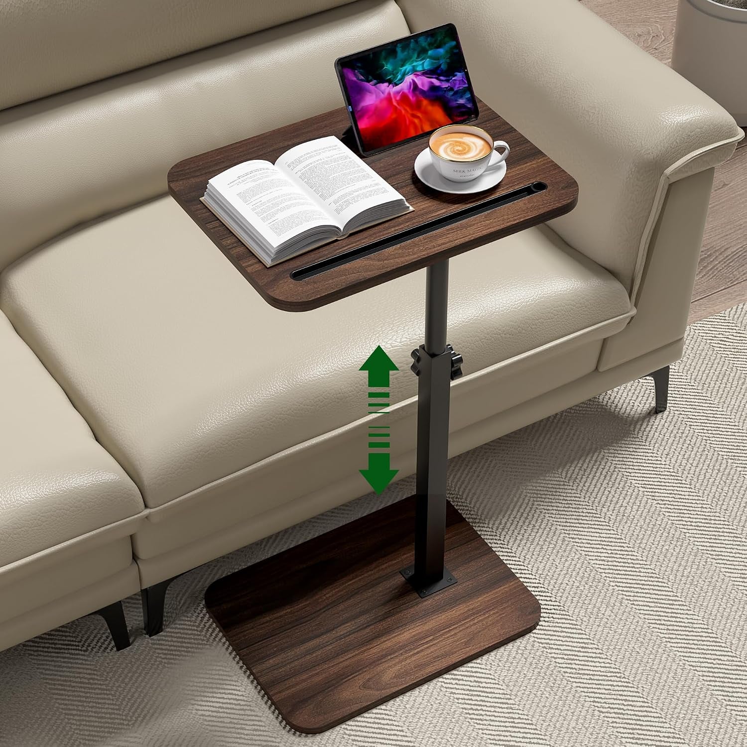 C-shaped side table with dark wood top and base beside a beige sofa, tablet and book on top