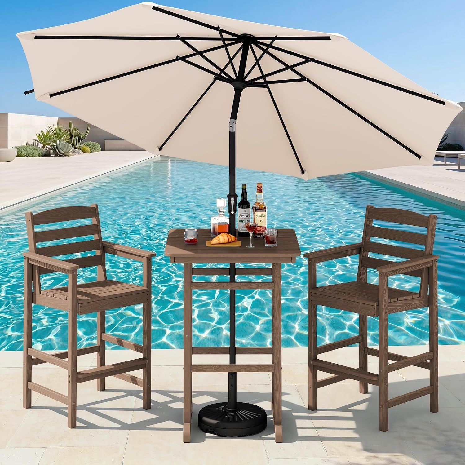Light brown bar table and two matching bar chairs beside a pool under a large beige umbrella.
