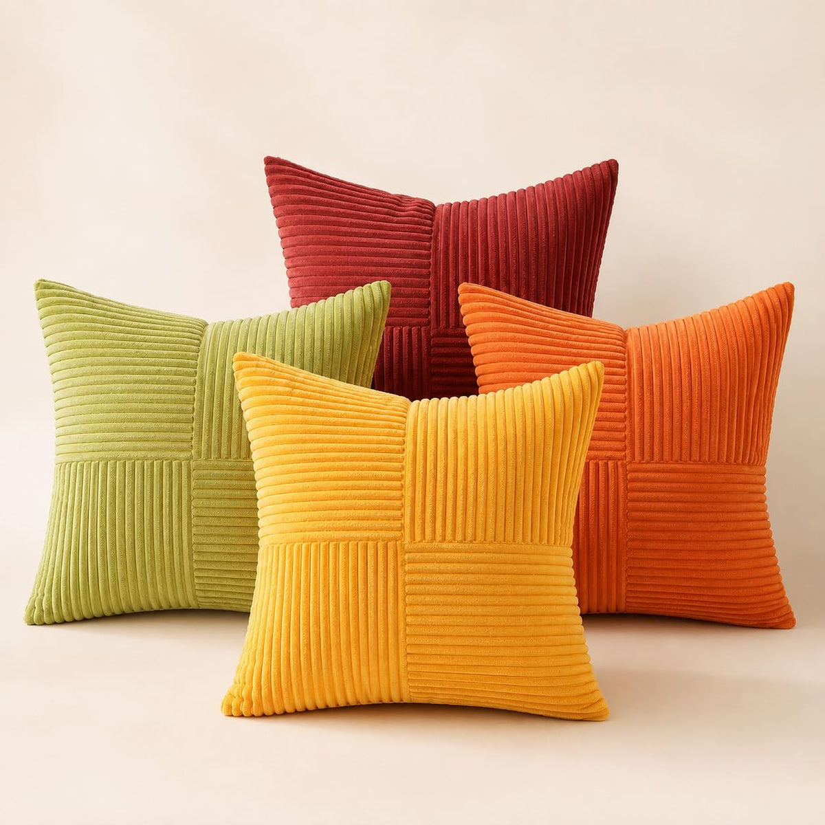 Four ribbed velvet pillow covers in warm colors—mustard, orange, lime green and deep red—on a neutral background.