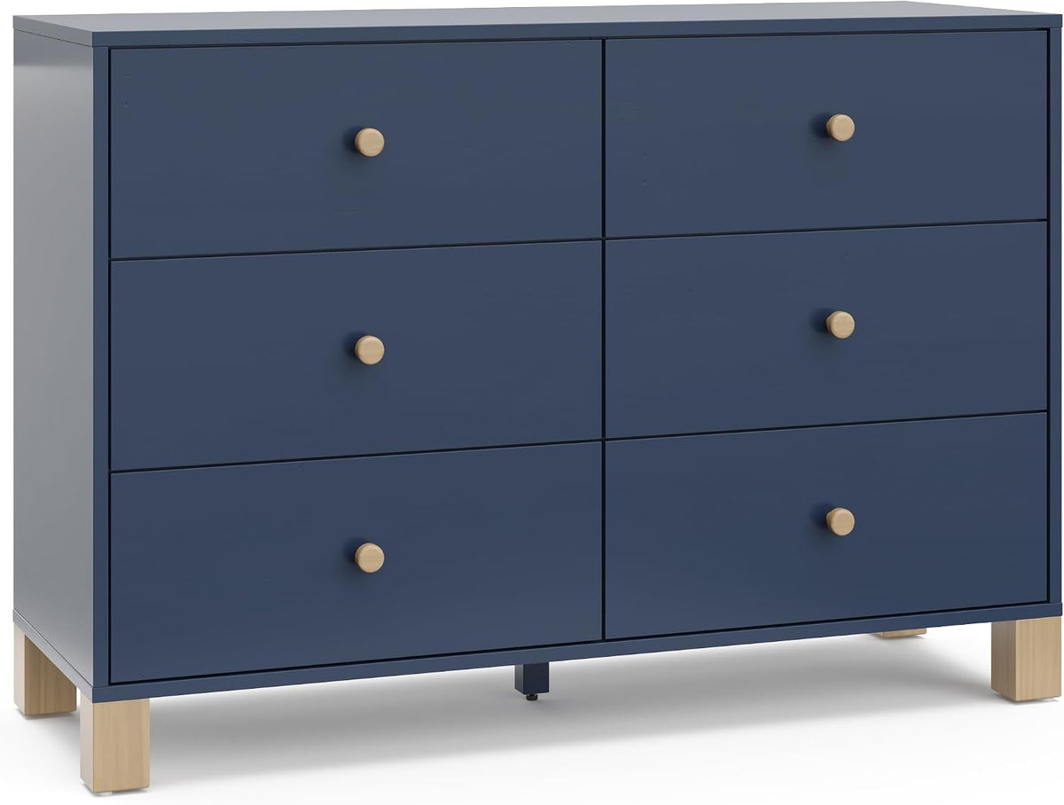 Six-drawer navy dresser with round wood knobs and light wood block legs, shown from the front.