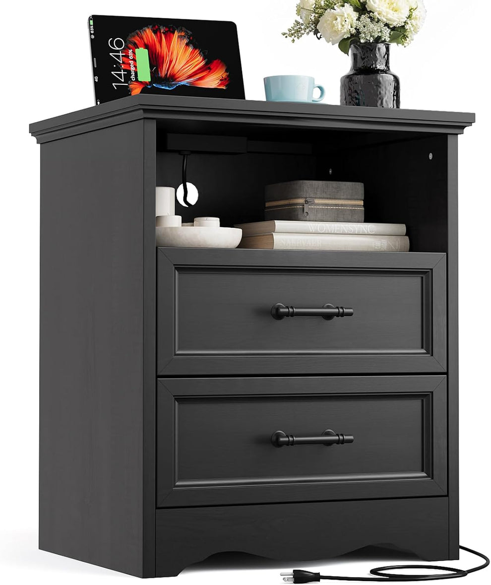 Black two-drawer nightstand angled front view showing open shelf and top charging outlet