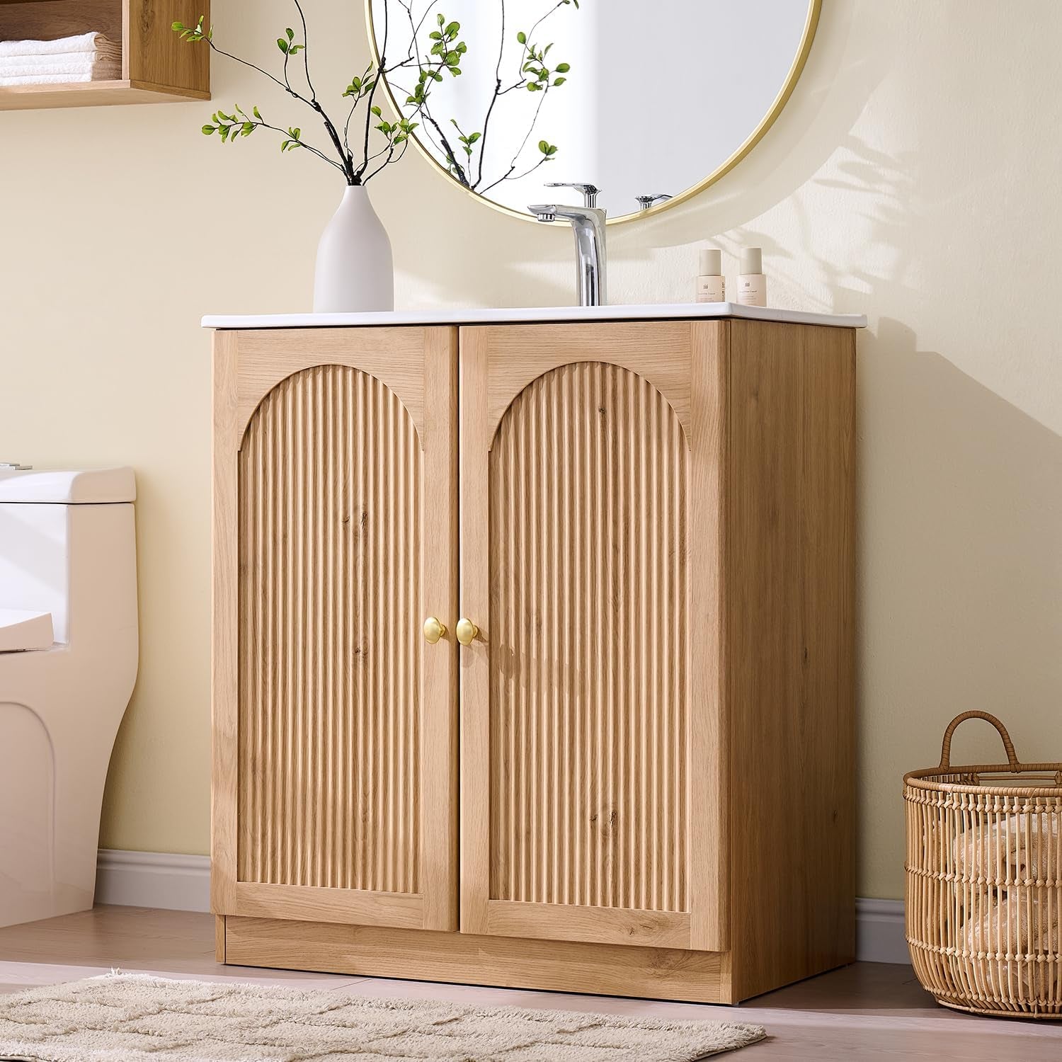 Natural oak 30-inch freestanding vanity with arched fluted doors and white integrated sink, angled front view