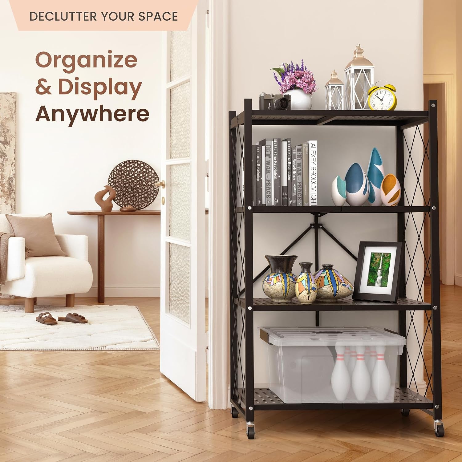 Black metal shelving unit styled in an entryway with books, vases and a storage bin on its shelves