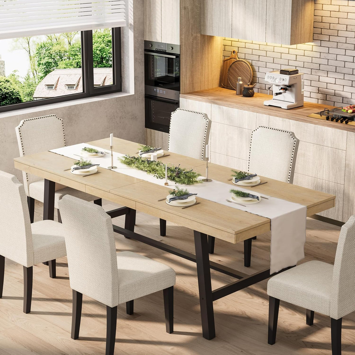 Dining room scene showing a light wood extendable table with black metal legs and upholstered chairs.