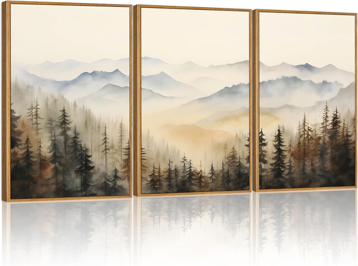 Three vertical light-wood framed canvas panels showing misty mountains and evergreen silhouettes in soft sage and beige