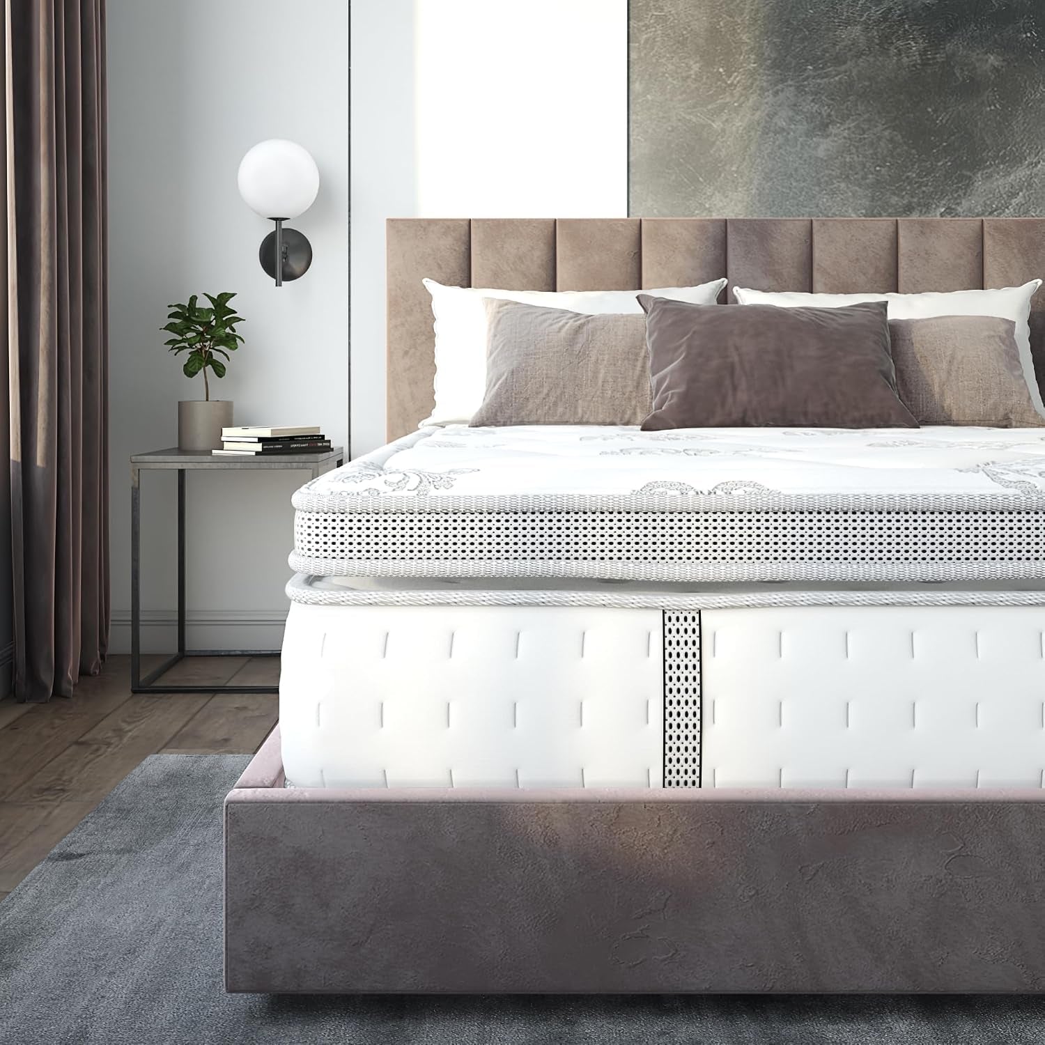 Front-facing crop of mattress showing central dotted fabric strip, pillow-top layers, tufted headboard and left side table.